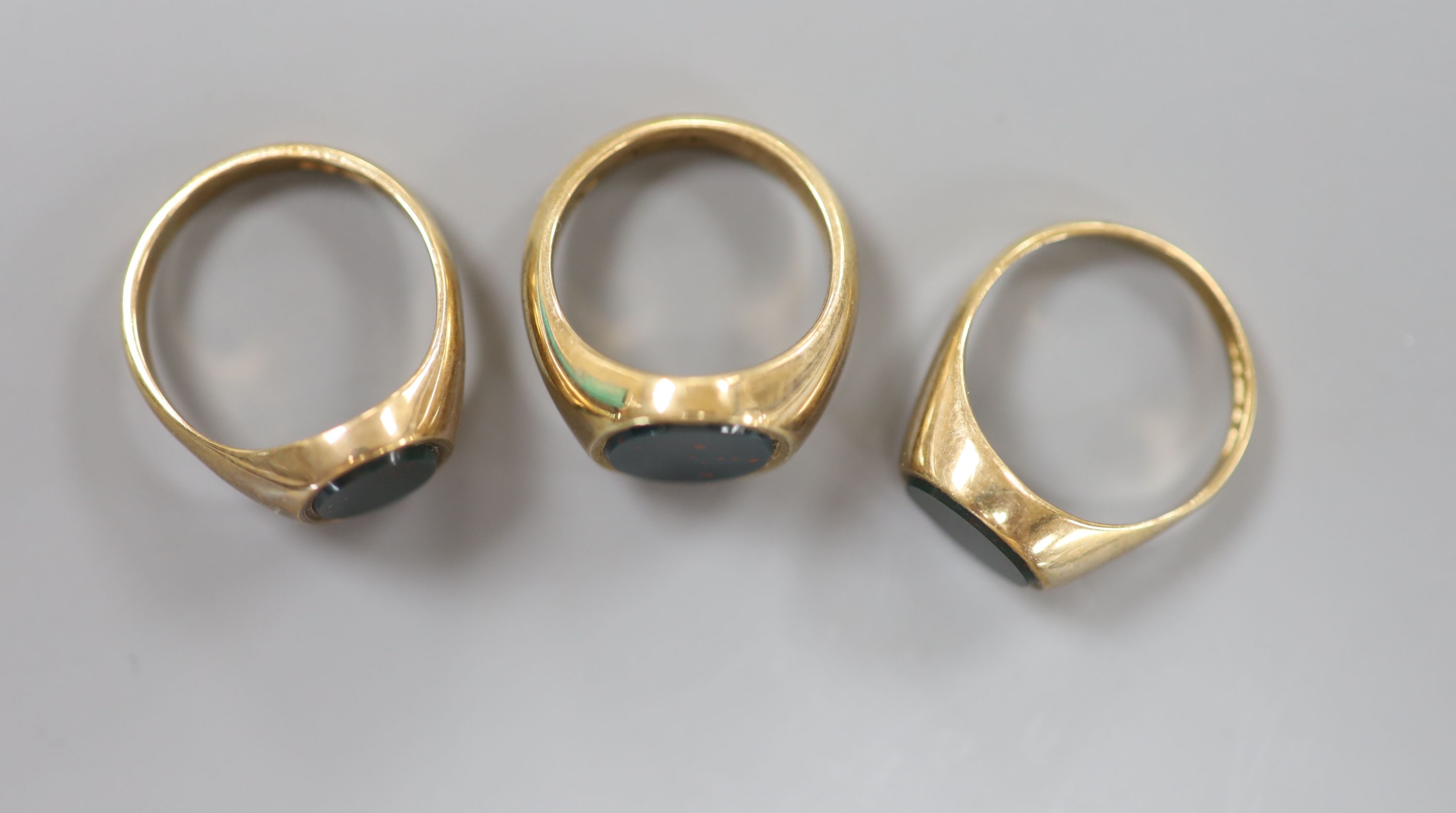Three assorted modern 9ct gold and bloodstone set signet rings, sizes J,N, & O